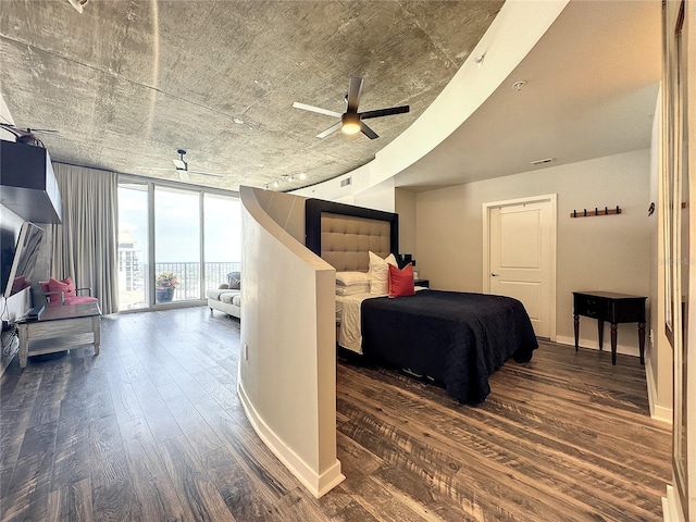 bedroom featuring baseboards, floor to ceiling windows, access to exterior, visible vents, and wood finished floors