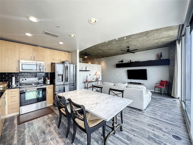 kitchen featuring dark wood finished floors, light brown cabinets, appliances with stainless steel finishes, and ceiling fan
