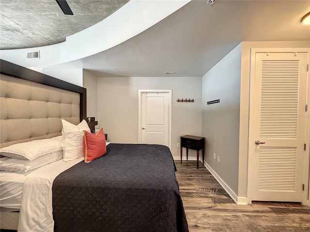 bedroom featuring a ceiling fan, baseboards, and wood finished floors