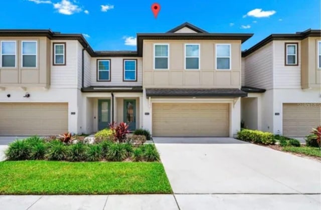 832 Benoi Dr, Davenport, FL 33896 - view of front of house with driveway, stucco siding, and an attached garage