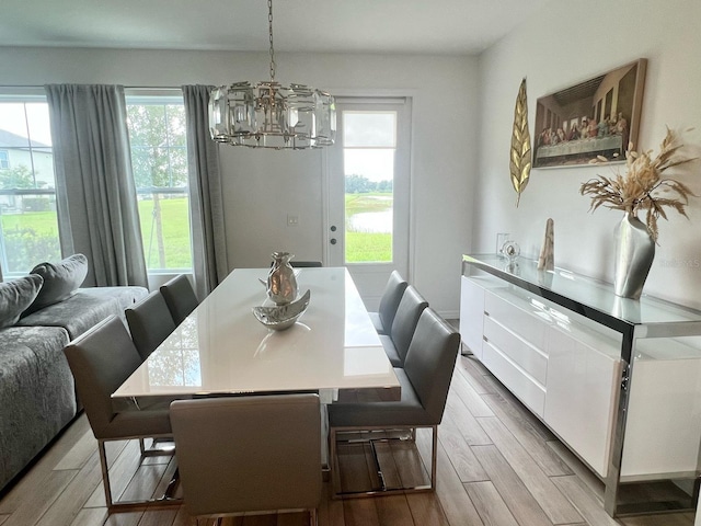 832 Benoi Dr, Davenport, FL 33896 - dining space featuring wood tiled floor, a wealth of natural light, and an inviting chandelier