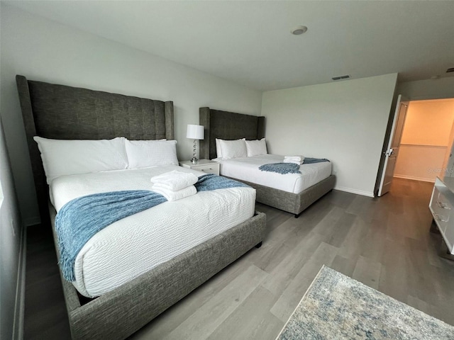 832 Benoi Dr, Davenport, FL 33896 - bedroom featuring wood finished floors, baseboards, and visible vents