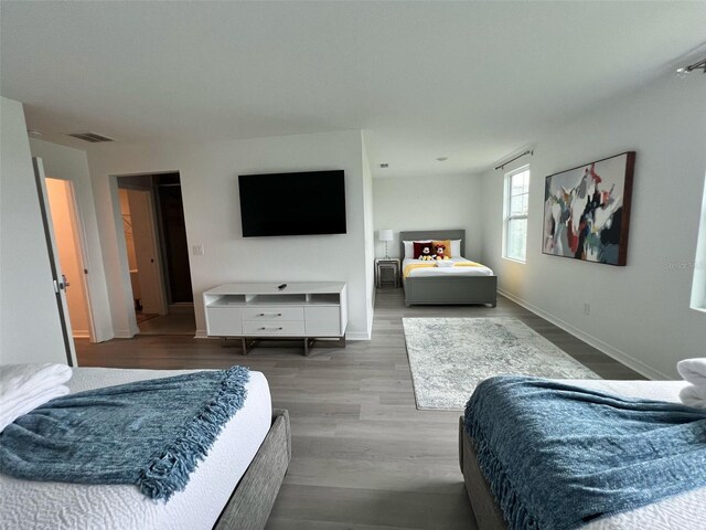 832 Benoi Dr, Davenport, FL 33896 - bedroom featuring baseboards, visible vents, and wood finished floors
