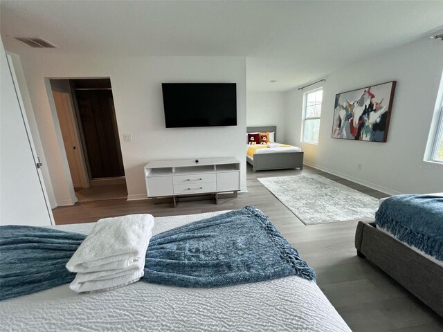 832 Benoi Dr, Davenport, FL 33896 - bedroom featuring wood finished floors, baseboards, and visible vents