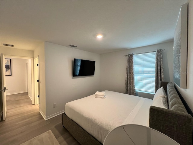 832 Benoi Dr, Davenport, FL 33896 - bedroom with baseboards, visible vents, and wood finished floors