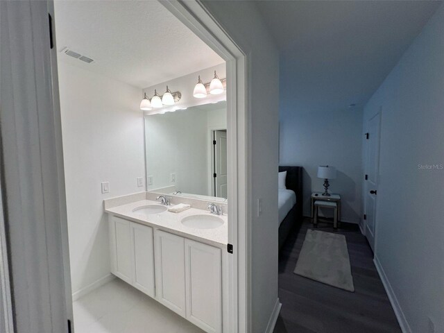 832 Benoi Dr, Davenport, FL 33896 - bathroom featuring double vanity, visible vents, baseboards, and a sink
