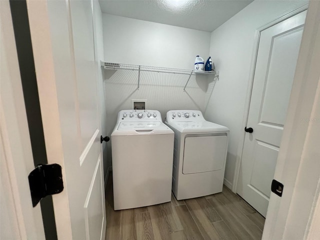832 Benoi Dr, Davenport, FL 33896 - laundry area with washing machine and dryer, laundry area, and wood finished floors