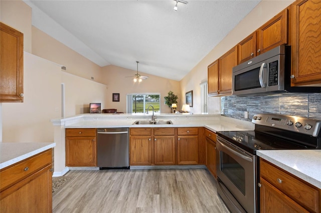 kitchen featuring light countertops, a sink, and appliances with stainless steel finishes