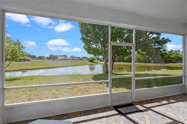 unfurnished sunroom with a water view and a wealth of natural light