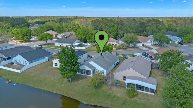 birds eye view of property featuring a residential view, a water view, and a forest view