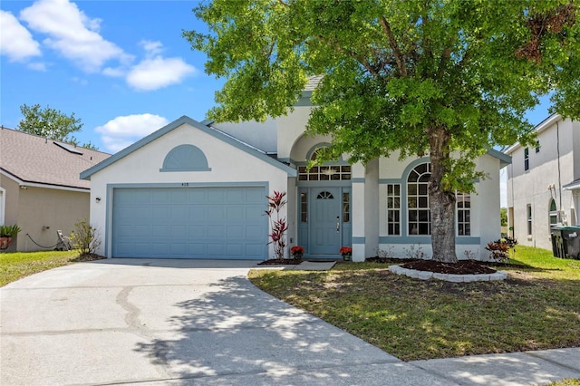 view of front of home with driveway, stucco siding, and an attached garage