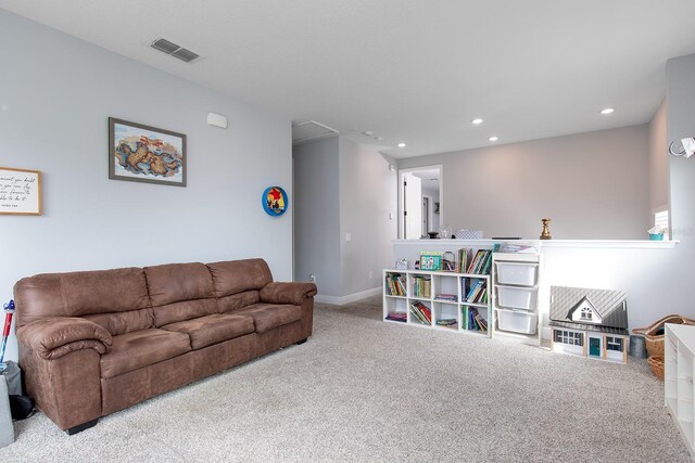 living area featuring visible vents, baseboards, recessed lighting, attic access, and carpet floors