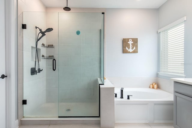 full bath featuring a shower stall, vanity, and a bath