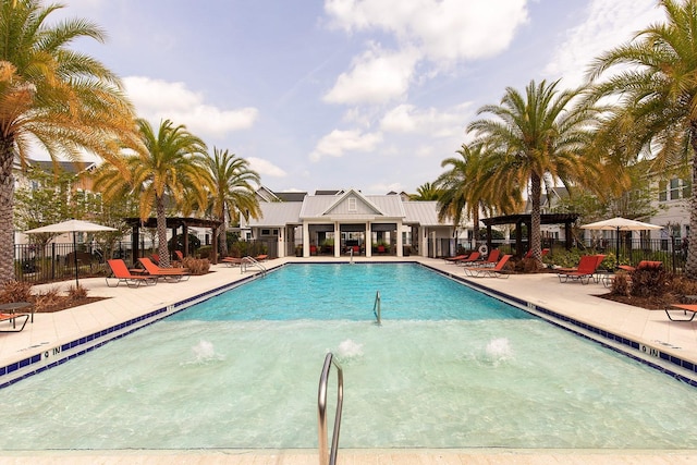 pool with fence and a patio
