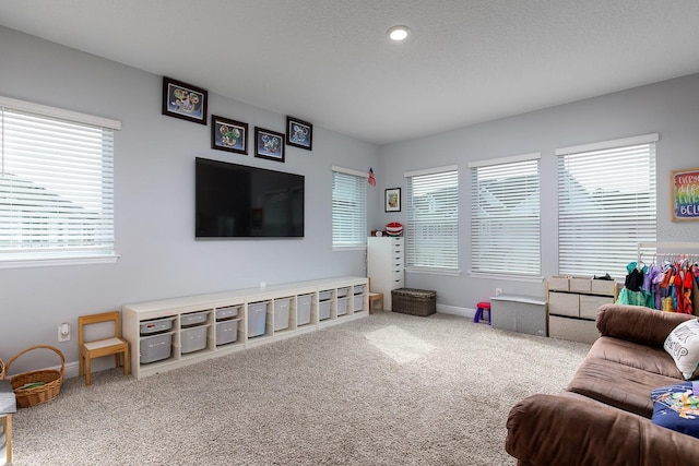 living area featuring baseboards and carpet flooring