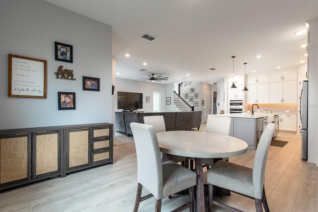 dining room featuring stairs, recessed lighting, light wood-style floors, visible vents, and a ceiling fan