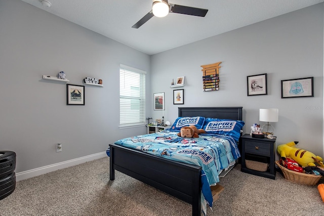 carpeted bedroom featuring baseboards and a ceiling fan