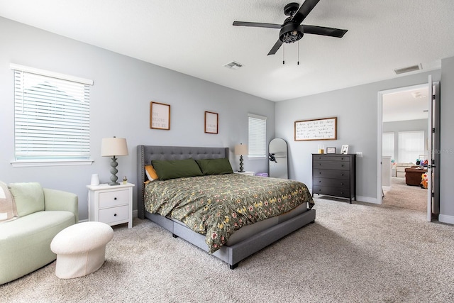 bedroom with carpet flooring, a ceiling fan, a textured ceiling, and visible vents