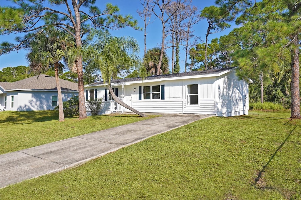 437 Truvall St SW, Palm Bay, FL 32908 - ranch-style home with driveway and a front lawn