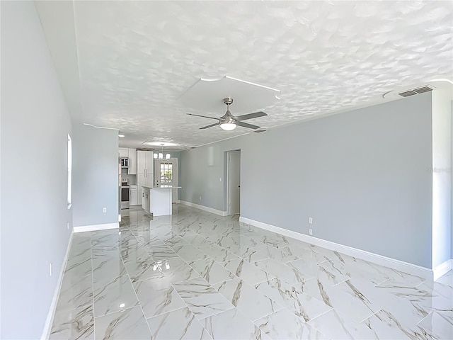 123 Shenandoah Ave, Lady Lake, FL 32159 - unfurnished living room featuring baseboards, visible vents, ceiling fan, and a textured ceiling