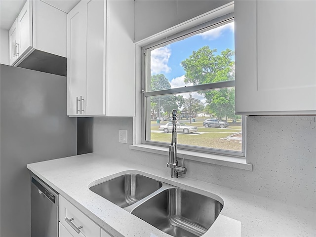 123 Shenandoah Ave, Lady Lake, FL 32159 - kitchen featuring dishwasher, a sink, white cabinetry, and light stone counters
