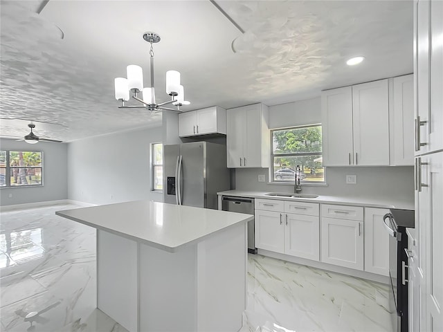 123 Shenandoah Ave, Lady Lake, FL 32159 - kitchen featuring marble finish floor, a sink, stainless steel appliances, and plenty of natural light