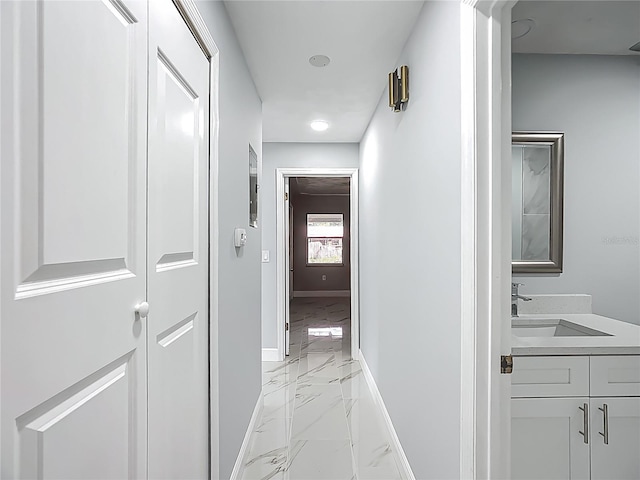 123 Shenandoah Ave, Lady Lake, FL 32159 - hallway with marble finish floor, baseboards, and a sink