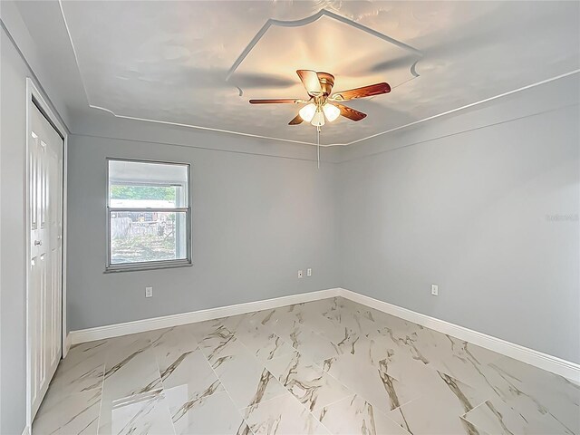 123 Shenandoah Ave, Lady Lake, FL 32159 - spare room featuring marble finish floor, baseboards, and ceiling fan