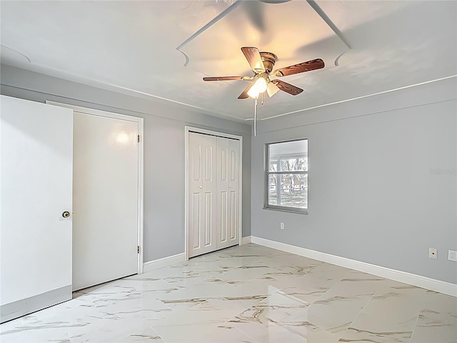 123 Shenandoah Ave, Lady Lake, FL 32159 - unfurnished bedroom featuring marble finish floor, baseboards, and a ceiling fan