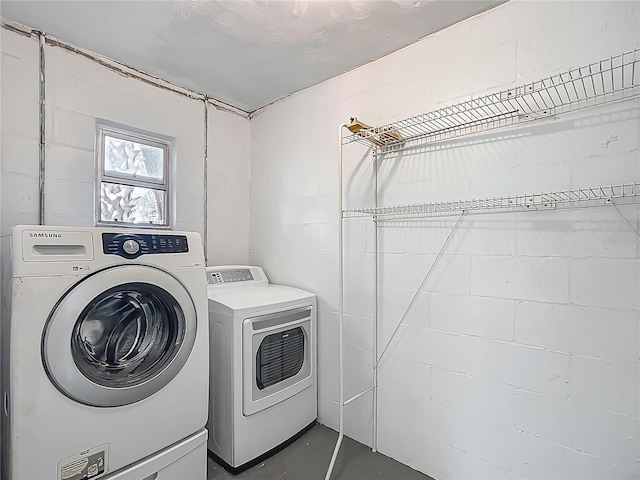 123 Shenandoah Ave, Lady Lake, FL 32159 - washroom with washing machine and clothes dryer, concrete block wall, and laundry area