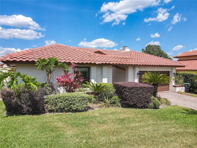 7808 The Esplanade Ct, Orlando, FL 32836 - mediterranean / spanish house featuring a garage, stucco siding, a front yard, and a tile roof