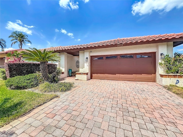 7808 The Esplanade Ct, Orlando, FL 32836 - mediterranean / spanish-style home featuring stucco siding, decorative driveway, an attached garage, and a tiled roof