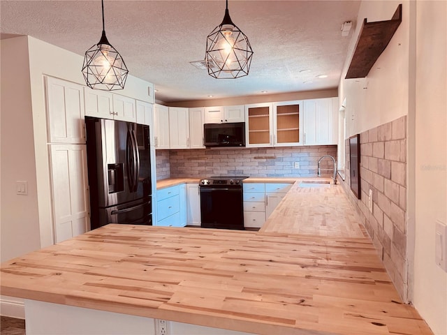 7808 The Esplanade Ct, Orlando, FL 32836 - kitchen with electric stove, stainless steel fridge, wooden counters, black microwave, and a textured ceiling