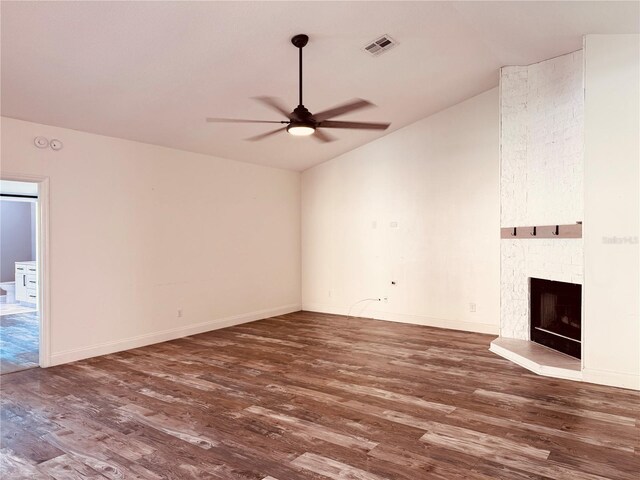 7808 The Esplanade Ct, Orlando, FL 32836 - unfurnished living room featuring vaulted ceiling, a ceiling fan, wood finished floors, and a large fireplace