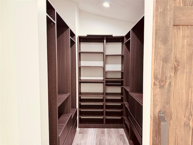 7808 The Esplanade Ct, Orlando, FL 32836 - walk in closet with wood finished floors and vaulted ceiling