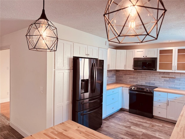 7808 The Esplanade Ct, Orlando, FL 32836 - kitchen with stainless steel fridge with ice dispenser, electric stove, wooden counters, wood finished floors, and a chandelier