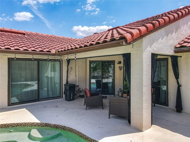 7808 The Esplanade Ct, Orlando, FL 32836 - rear view of property featuring stucco siding, a patio, a tile roof, and an outdoor living space