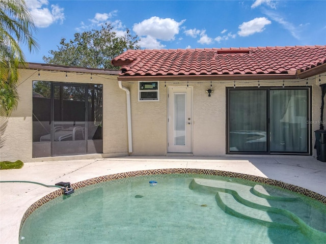 7808 The Esplanade Ct, Orlando, FL 32836 - rear view of property with stucco siding, an outdoor pool, a patio, and a tile roof