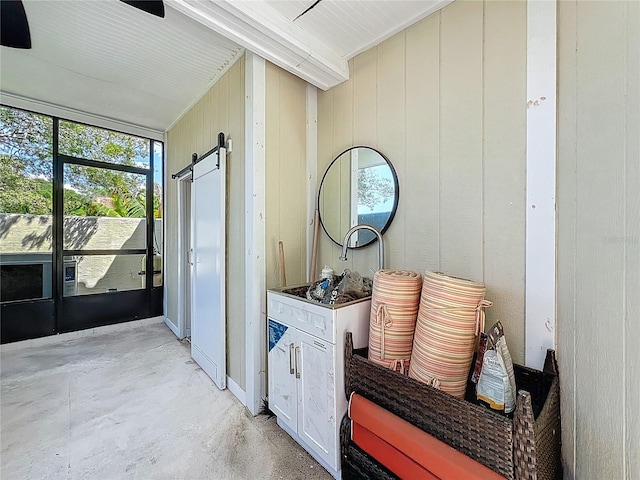 7808 The Esplanade Ct, Orlando, FL 32836 - corridor with a barn door and unfinished concrete floors