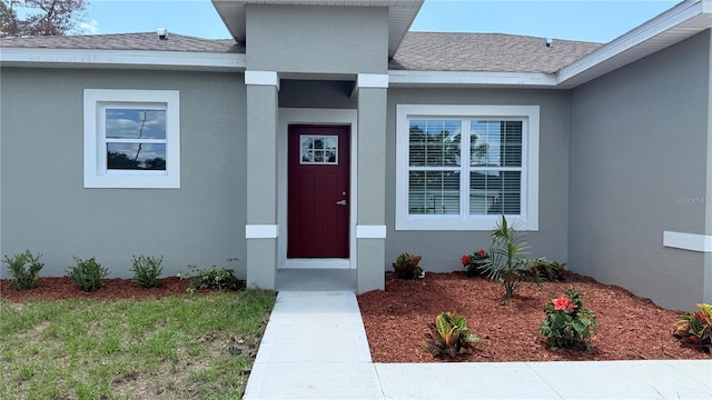 6345 SW 155th Pl, Ocala, FL 34473 - property entrance featuring a shingled roof and stucco siding