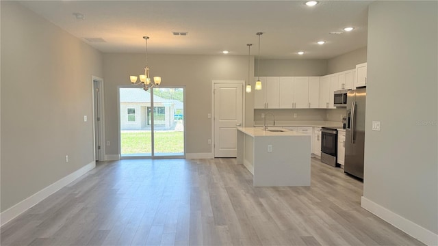6345 SW 155th Pl, Ocala, FL 34473 - kitchen featuring appliances with stainless steel finishes, a sink, light wood-style floors, light countertops, and baseboards