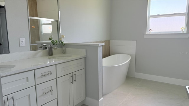 6345 SW 155th Pl, Ocala, FL 34473 - full bath featuring a soaking tub, baseboards, and double vanity