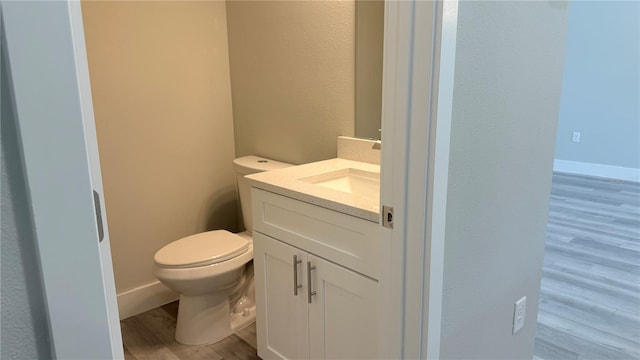 6345 SW 155th Pl, Ocala, FL 34473 - half bathroom with wood finished floors, vanity, toilet, and a textured wall