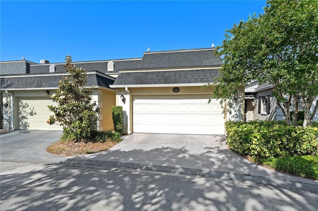 908 Hillary Ct Unit 15, Orlando, FL 32804 - multi unit property featuring mansard roof, an attached garage, driveway, and a shingled roof