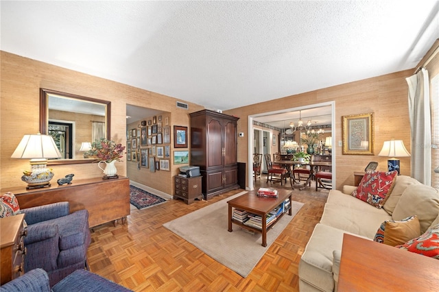 908 Hillary Ct Unit 15, Orlando, FL 32804 - living room with wooden walls, visible vents, a notable chandelier, and a textured ceiling