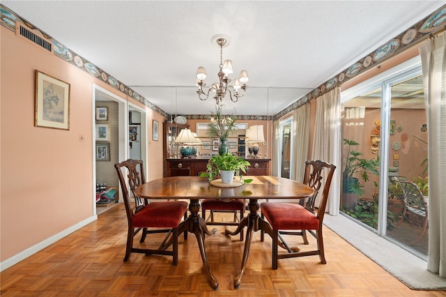 908 Hillary Ct Unit 15, Orlando, FL 32804 - dining room featuring a notable chandelier, baseboards, and visible vents