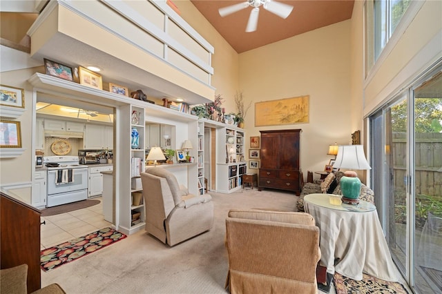 908 Hillary Ct Unit 15, Orlando, FL 32804 - living area with ceiling fan, a towering ceiling, and light carpet
