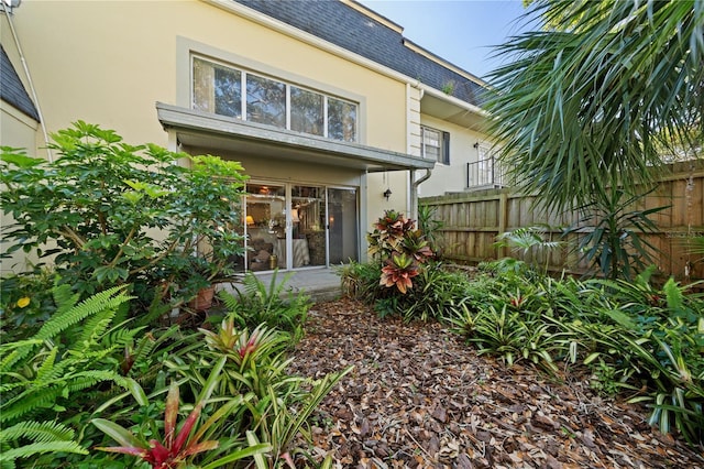 908 Hillary Ct Unit 15, Orlando, FL 32804 - rear view of property with stucco siding, fence, and a shingled roof