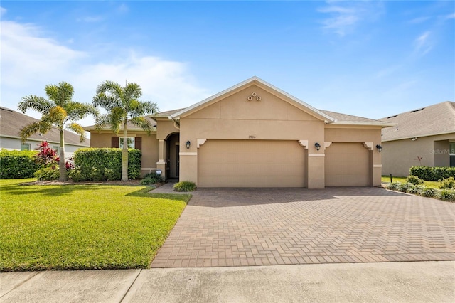 3936 Parkhouse Dr, Orlando, FL 32824 - ranch-style home featuring stucco siding, an attached garage, a front yard, and decorative driveway