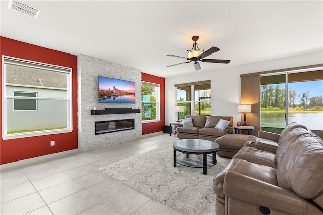 3936 Parkhouse Dr, Orlando, FL 32824 - tiled living area featuring a large fireplace, visible vents, and ceiling fan